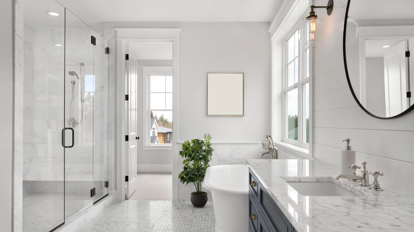 Marble bathroom with freestanding tub and glass shower in an Upper East Side pre-war apartment