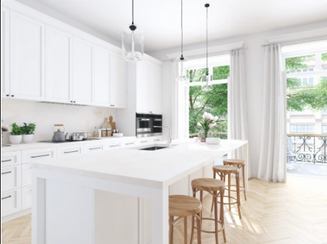 Modern white kitchen with natural light, wood stools, and large windows overlooking Manhattan