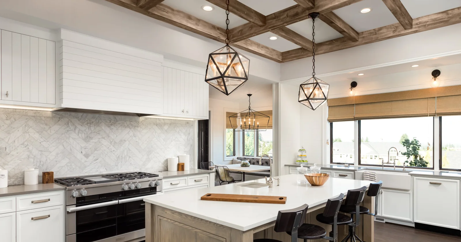 Custom kitchen with oak island and marble herringbone backsplash in a Carnegie Hill apartment