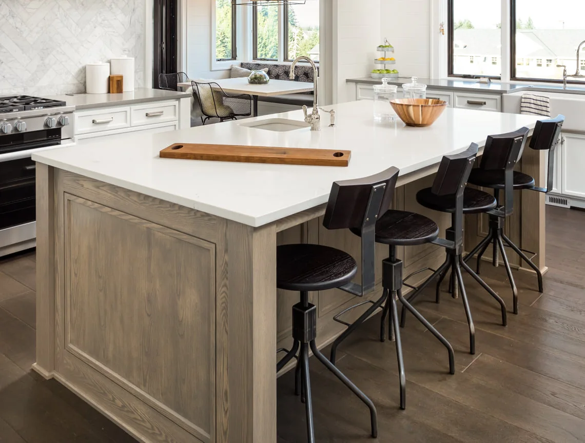 Oak island with quartz top and counter seating in a Museum Mile apartment kitchen