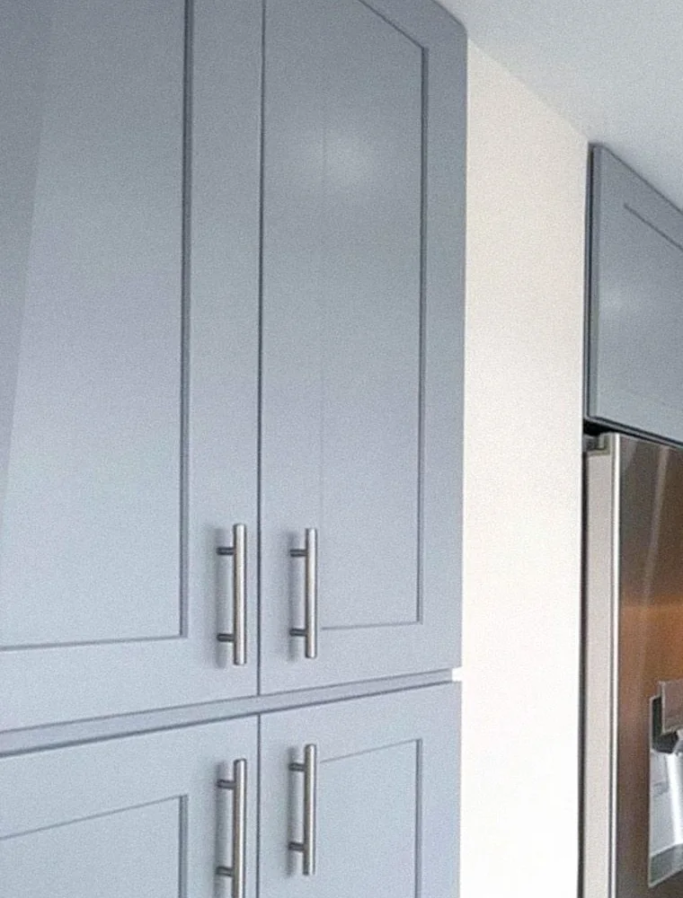 Detail of custom gray shaker cabinet fronts with brushed steel bar pulls, Lenox Hill kitchen