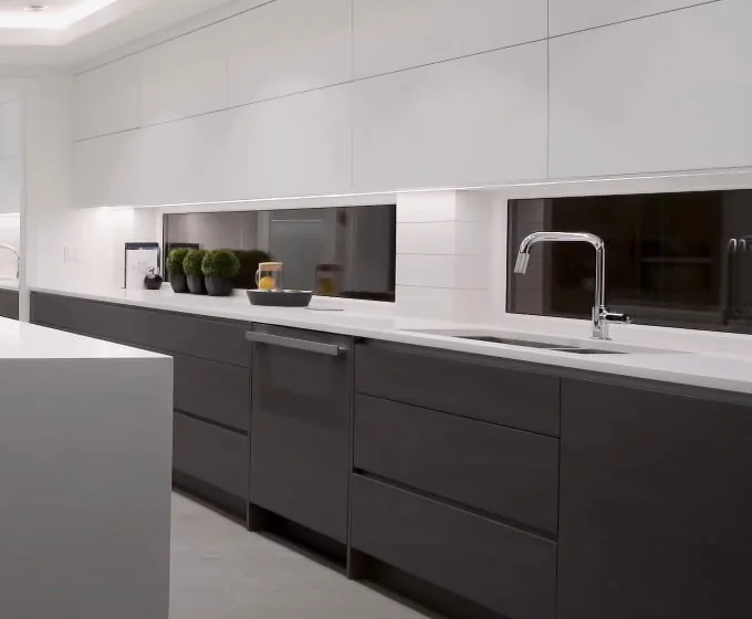 Handleless cabinet run with integrated appliances in an Upper West Side tower kitchen