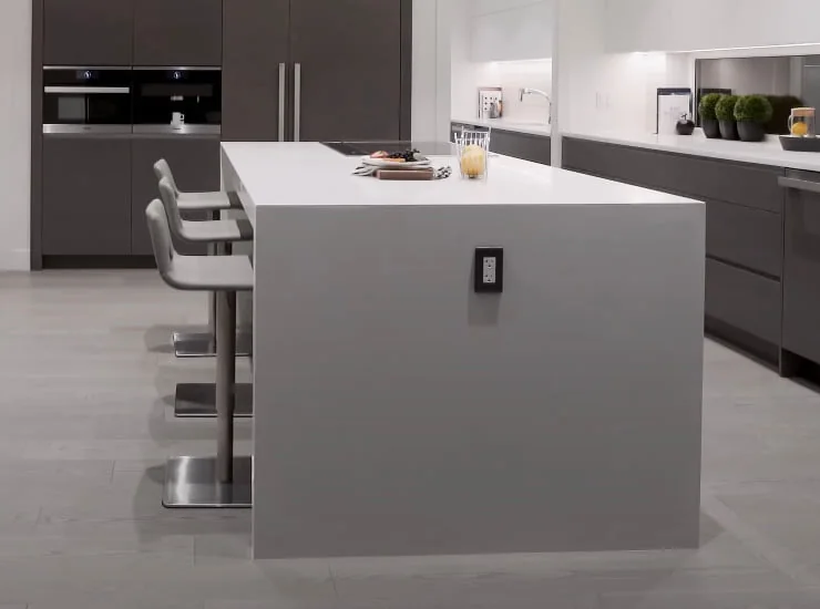 Waterfall quartz island with counter seating in a Lincoln Center area condo kitchen
