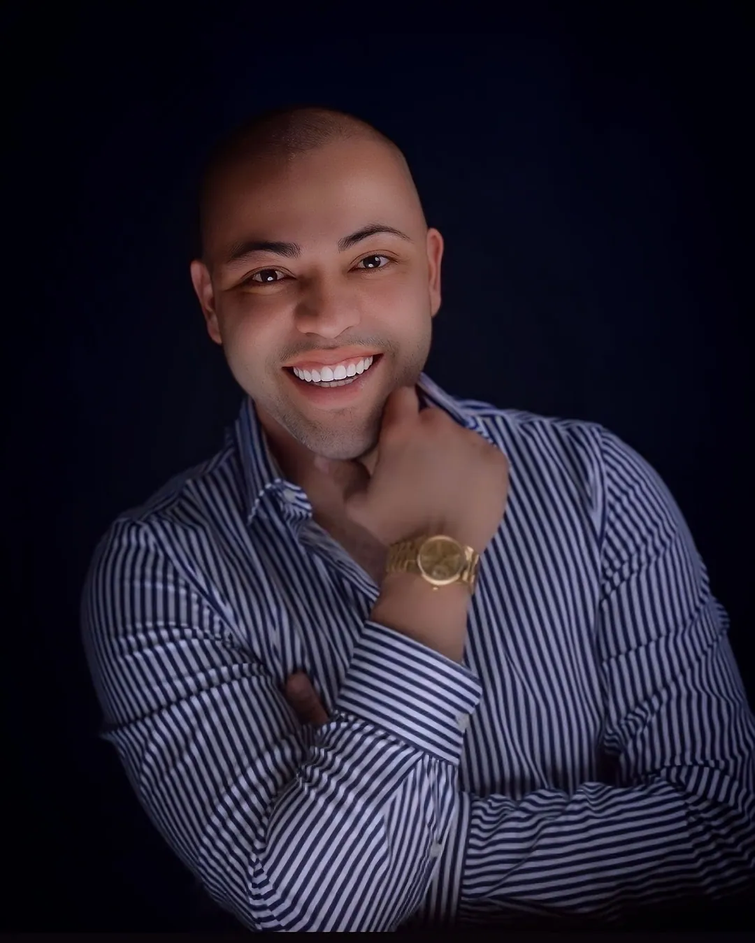John Posada, founder and general contractor of Home Design & Co, smiling in a striped shirt