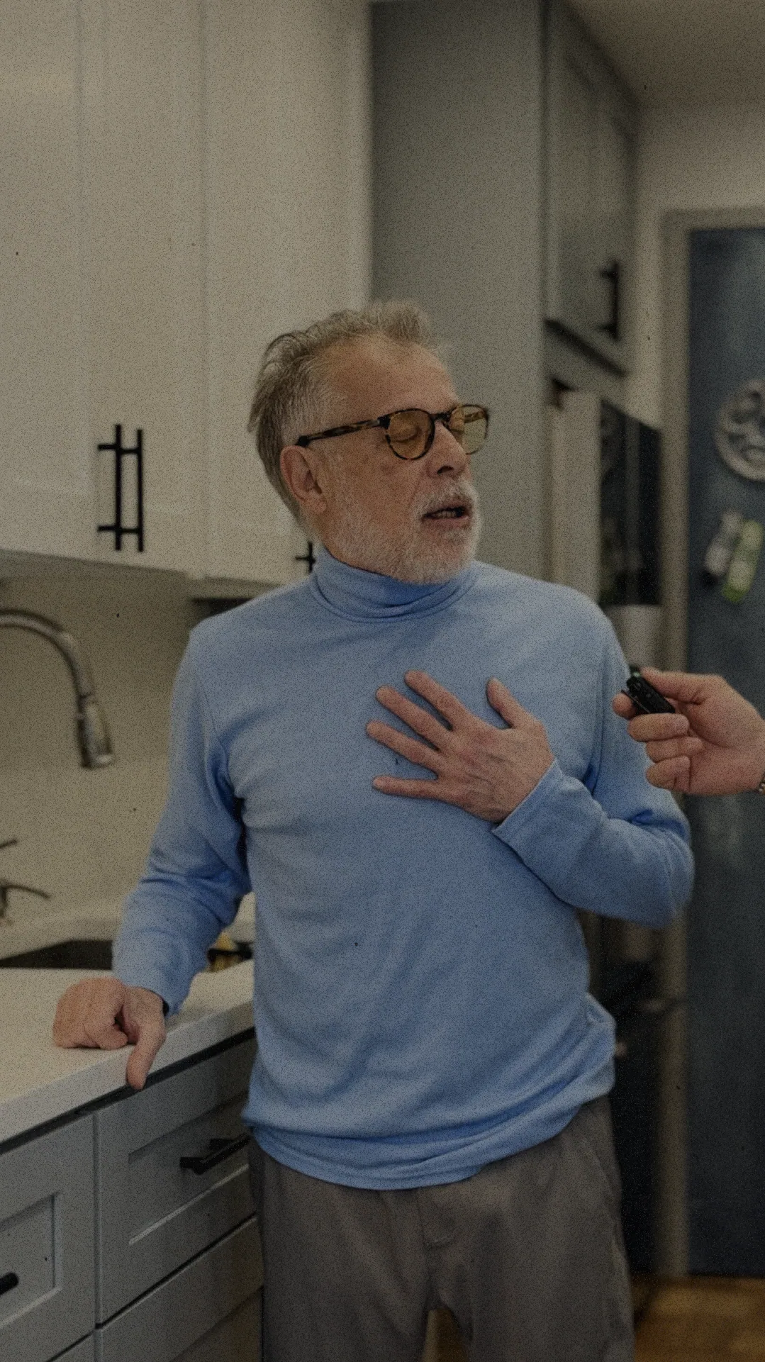John Andreoti, Home Design & Co client in Riverdale, NYC, standing in his renovated kitchen